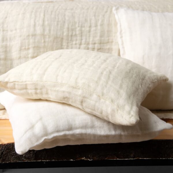 white cream linen bedspread, with decorative cushions