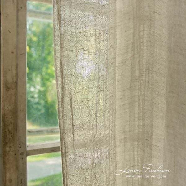 Light grey coloured 100% linen curtain.