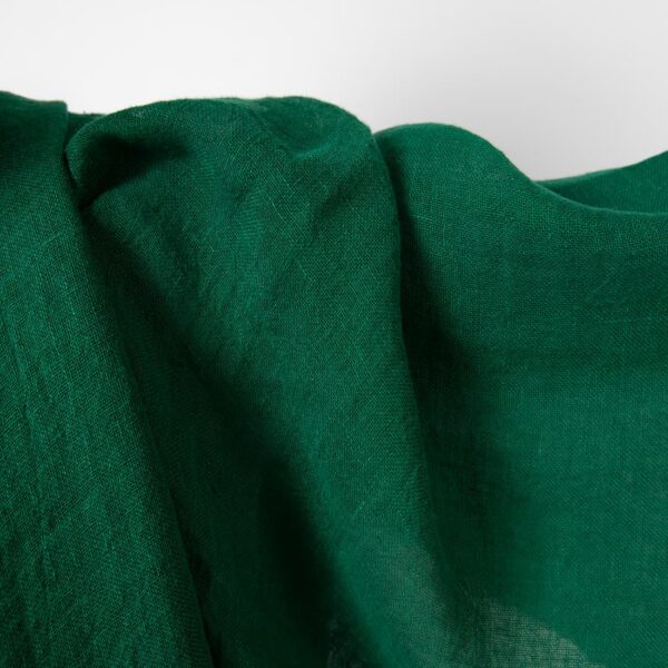 Washed linen fabric emerald green transparent close up detail view
