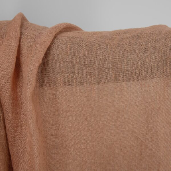 Washed sheer linen fabric light clay colour close up detail