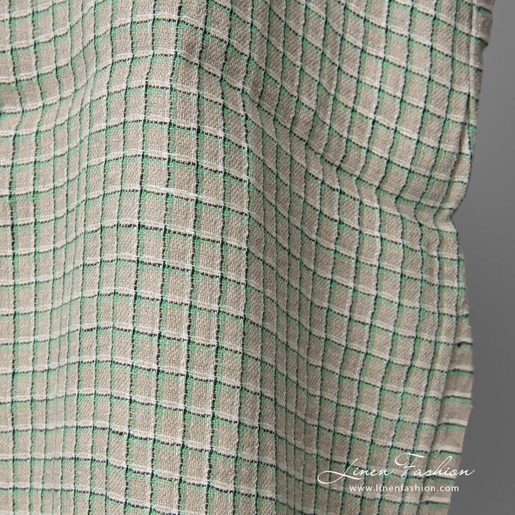 Pellavanharmaa kangas vihreillä ruuduilla pesty 3 This grey linen fabric is strong, dense and opaque, perfect for blankets, clothing and curtains