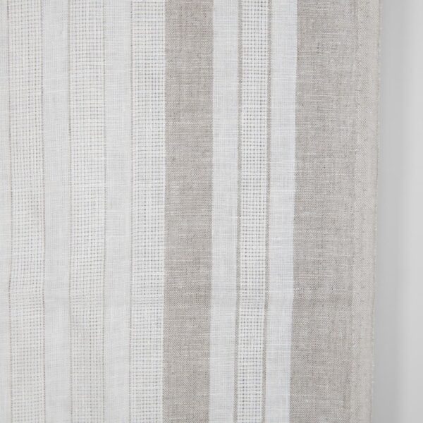 White linen fabric with undyed natural linen stripes close up photo