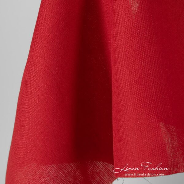 Solid red coloured linen fabric.