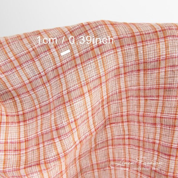 Checked linen fabric woven in white, orange, brown and red yarns